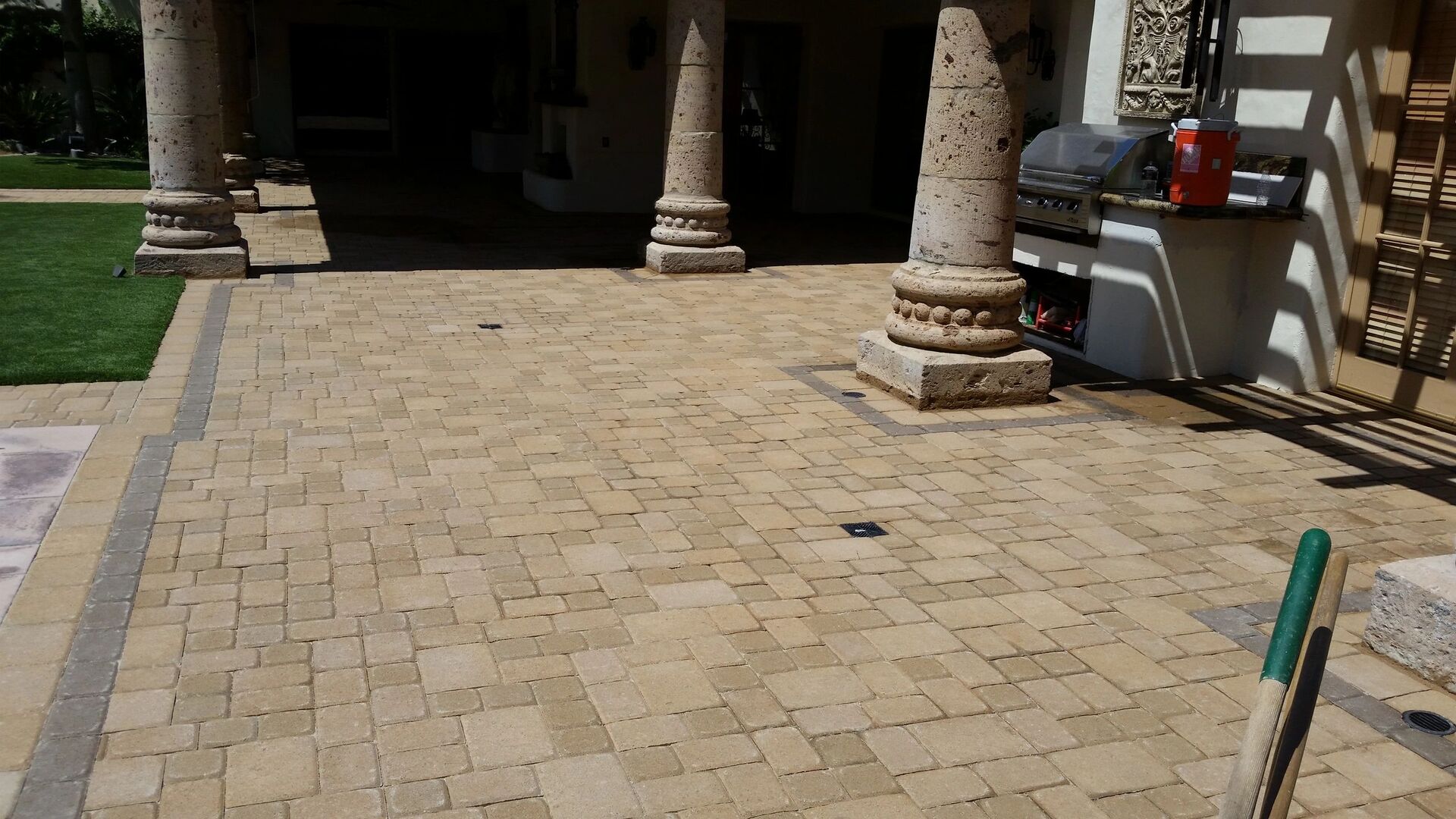 Luxury outdoor patio with built-in grill and columns