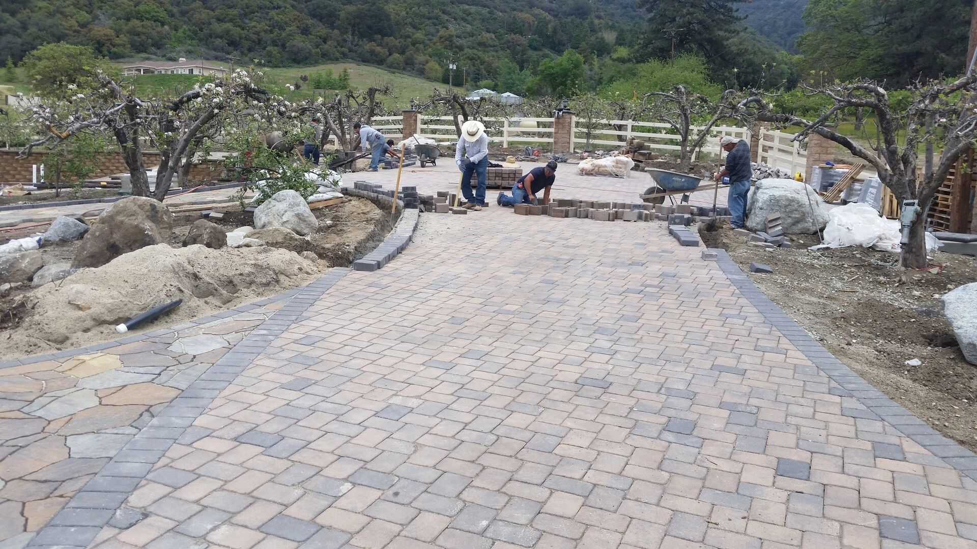 Crew installing paver pathway on a San Diego ranch property